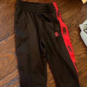 Nike Kids Black Joggers with Red Accents